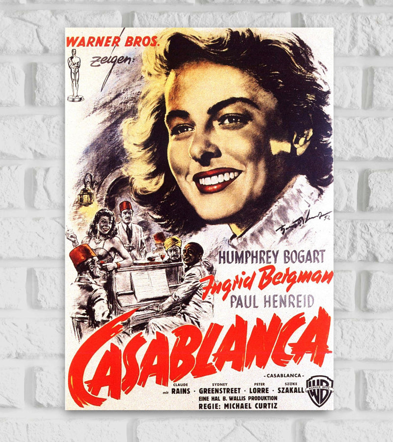 Vintage-style poster of Casablanca featuring a large illustrated portrait of Ingrid Bergman smiling, with scenes of a lively bar and characters in the background. The names Humphrey Bogart, Ingrid Bergman, and Paul Henreid are prominently displayed. The title “CASABLANCA” is written in bold red letters across the bottom. The poster includes classic 1940s design elements, showcasing the glamour and drama of the iconic film Hollywood Actress Action Drama Romance