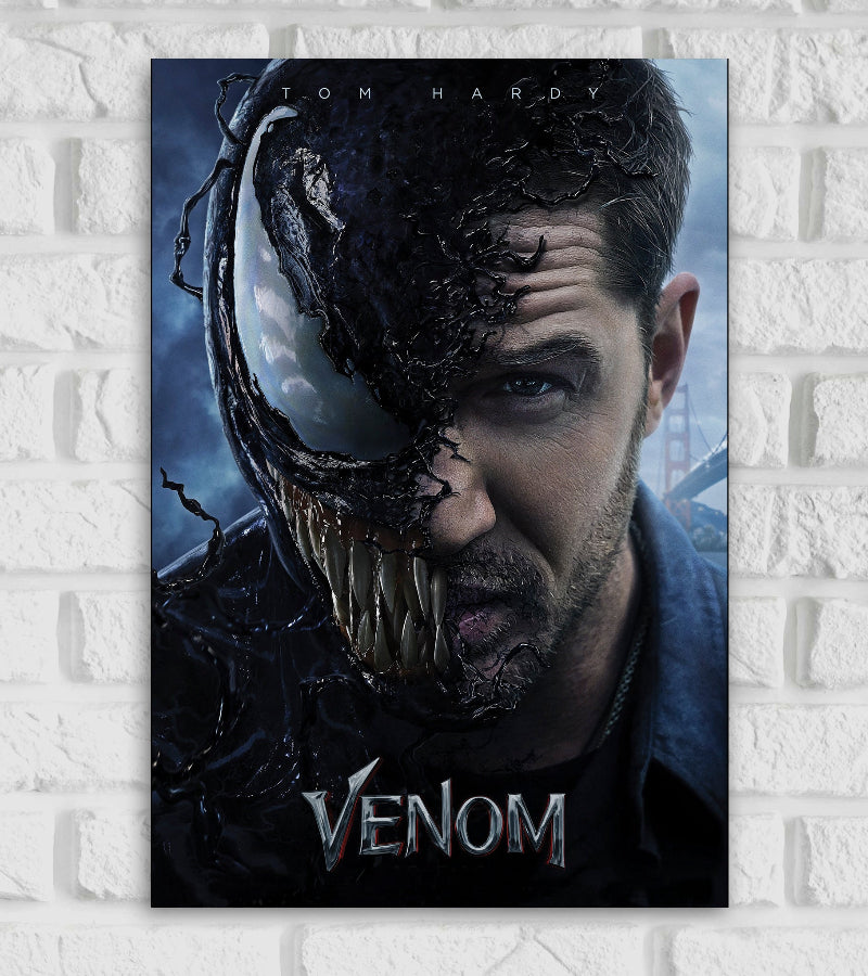 Poster for the Marvel film "Venom" featuring Tom Hardy The image shows a dramatic split face—half is Eddie Brock (played by Tom Hardy), and the other half is transformed into the menacing sharp-toothed symbiote Venom The black alien substance is shown creeping across his face with a monstrous eye jagged teeth visible The background includes a faint view of the Golden Gate Bridge suggesting the film's setting At the bottom the title "VENOM" is written in a metallic edgy font Hollywood American superhero