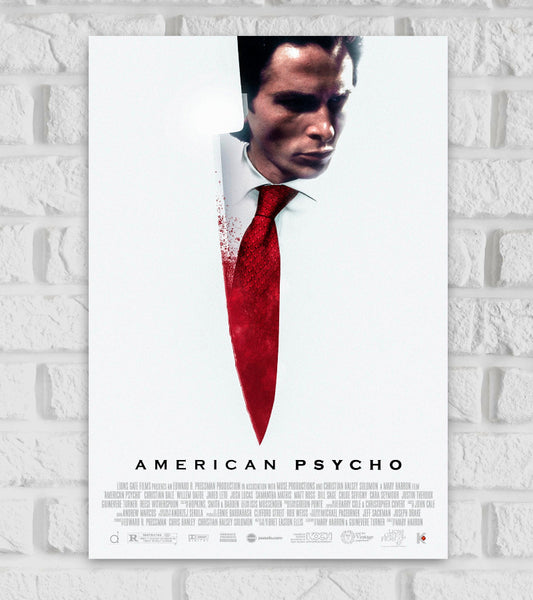 Poster of American Psycho featuring a minimalist design with a large white background. The central image shows a sharp knife, blending into the figure of a man in a white shirt and red tie, with blood splatters around the blade. The man's face appears intense and shadowed. The title "American Psycho" is displayed at the bottom in clean, bold black letters Horror Comedy Patrick Bateman Hollywood Action Drama Movies Actor