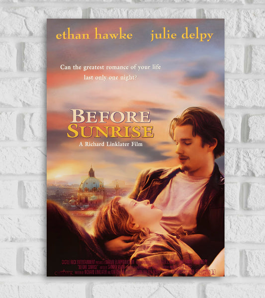 Poster of Hollywood American Drama directed by Richard Linklater. The image features Ethan Hawke and Julie Delpy in an intimate moment, with Hawke’s character gazing at Delpy, who is lying in his arms looking up at him. The background shows a dreamy, pastel-toned European cityscape at sunset with a golden sky and a domed cathedral. At the top, the actors’ names are written: “ethan hawke” followed by the tagline: “Can the greatest romance of your life last only one night