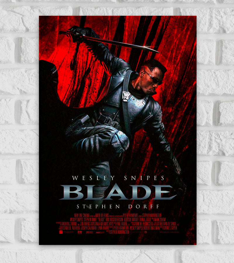 Poster of Blade featuring Wesley Snipes in full black armor and sunglasses, holding a sword in a dramatic action pose against a dark red and black streaked background. The title "Blade" is displayed in bold silver letters at the bottom, with the names Wesley Snipes and Stephen Dorff listed above and below it. The intense, dynamic design emphasizes the film’s dark, action-packed tone Action Horror American superhero Stephen Norrington David S. Goyer. Based on the Marvel Comics Blade Hollywood