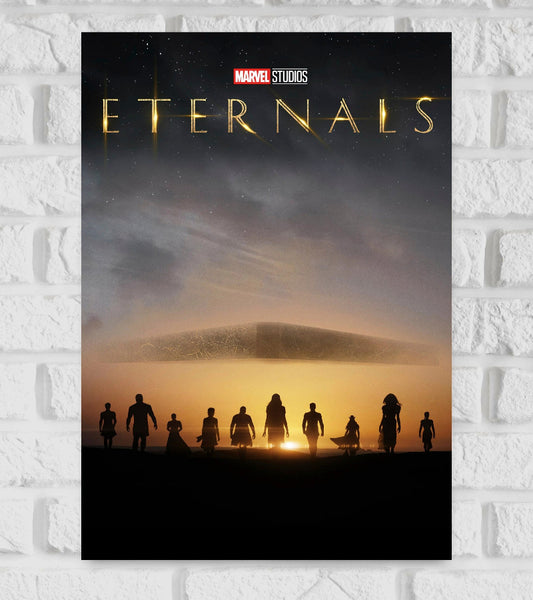 Poster of Eternals by Marvel Studios featuring the silhouettes of ten characters walking toward a glowing sunset, with a large, floating, ancient spaceship-like structure above them. The sky is dark and filled with stars, and the title "Eternals" appears at the top in golden, illuminated letters. The scene conveys a sense of mystery, power, and epic scale Hollywood American Marvel Studios Action Drama Thrill Adventure