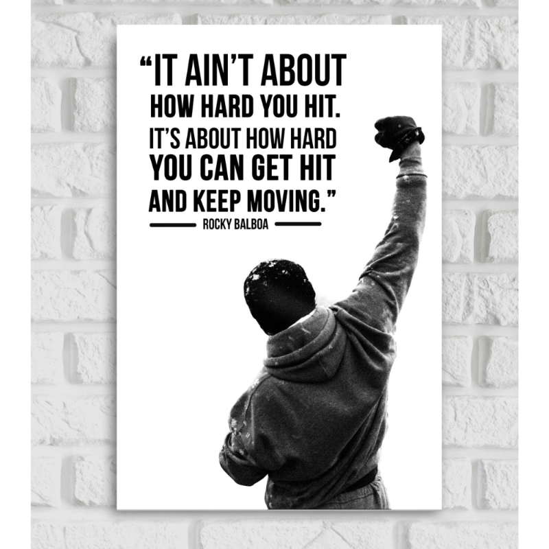 Poster of Rocky Balboa in black and white, showing the iconic scene of him from behind with one arm raised in triumph while wearing a hoodie and gloves. Above him is a motivational quote in bold black text: 'It ain’t about how hard you hit. It’s about how hard you can get hit and keep moving.' – Rocky Balboa.