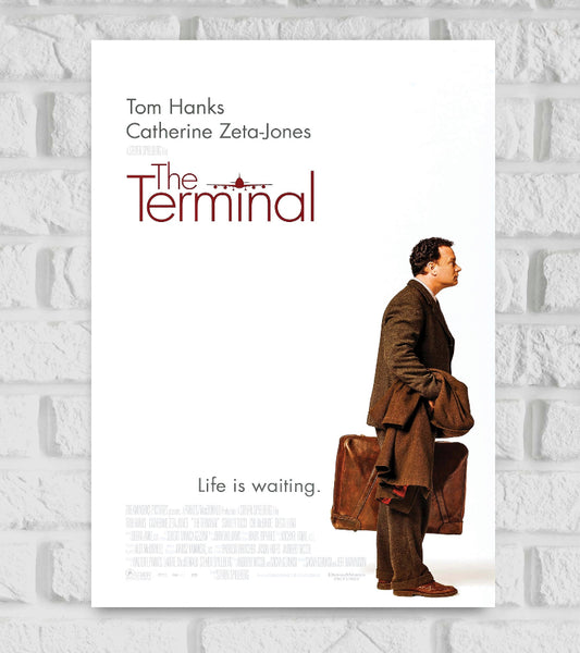 Poster of The Terminal featuring Tom Hanks standing in profile, holding a coat and suitcase, dressed in a brown suit. The background is minimalistic and white. The movie title “The Terminal” appears in elegant red text with an airplane graphic integrated into the lettering. Above it are the names Tom Hanks and Catherine Zeta-Jones. At the bottom, the tagline reads, “Life is waiting.” American comedy-drama film Hollywood Actor Movies