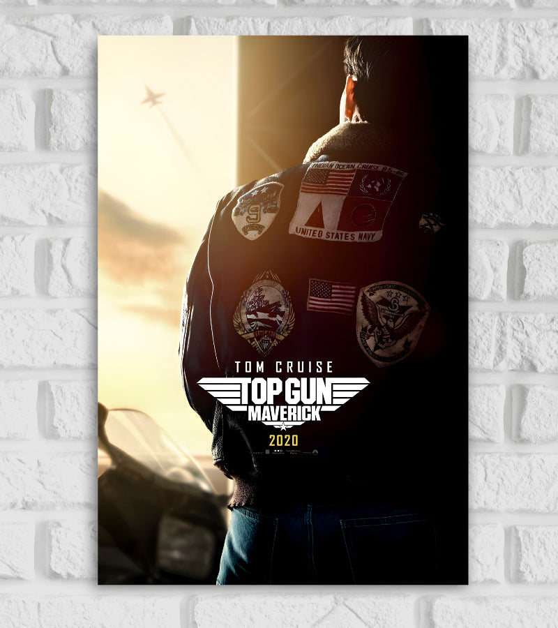 Poster of Top Gun: Maverick featuring the back view of Tom Cruise wearing a classic bomber jacket with various military patches. He stands next to a fighter jet with a warm sunset in the background. A jet is seen flying high in the sky, leaving a trail. The title “TOP GUN MAVERICK” is displayed in bold white text with wings below, along with “TOM CRUISE” and the release year “2020.” The imagery conveys themes of aviation, legacy, and nostalgia Hollywood Actor Actress Movies American action drama film