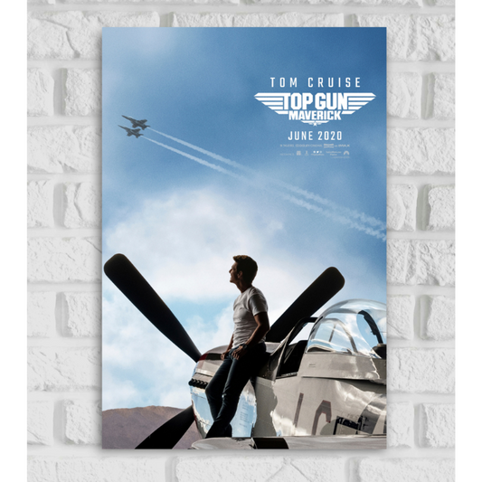 Poster of the movie 'Top Gun: Maverick' featuring Tom Cruise leaning against a vintage fighter plane, looking up at the sky. Two modern jets fly overhead, leaving white contrails across a clear blue sky. The text at the top reads 'TOM CRUISE' and 'TOP GUN MAVERICK' with a winged logo, along with the release date 'JUNE 2020
